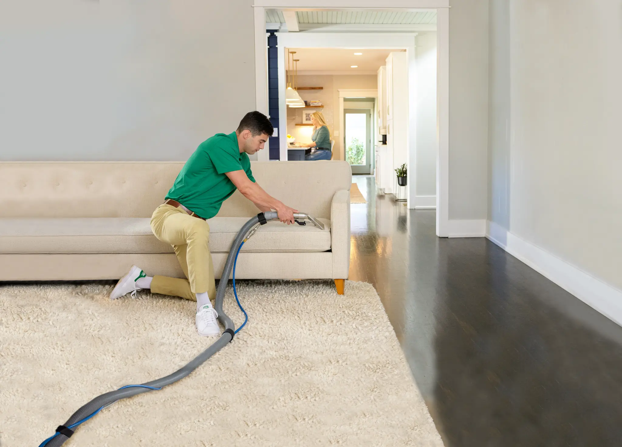 Chem-Dry technician professionally cleaning a light-coloured fabric sofa